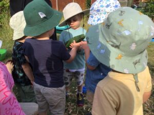 Children at Spring RAF Halton are holding vegetables they have grown at the nursery helping to Grow Sustainable Futures at Spring RAF Halton Nursery